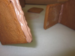 4. Pipe chocolate along the edge of the side of the back piece to match the front. Again, pipe extra chocolate inside to strengthen once in place.